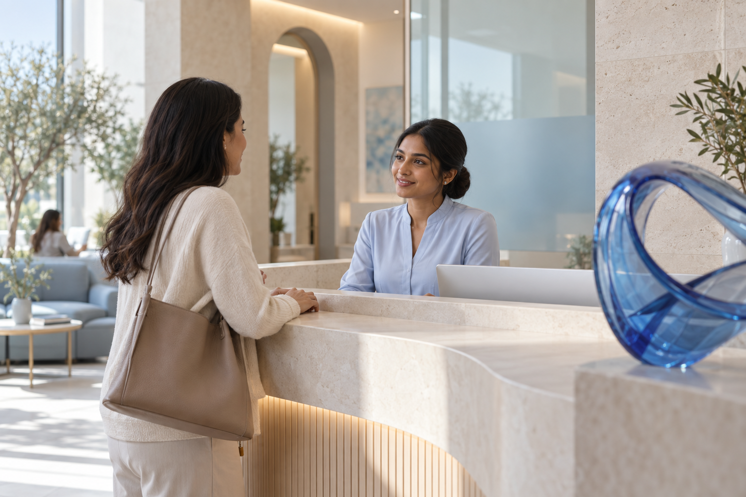 A welcoming clinic reception with a receptionist speaking to a visitor